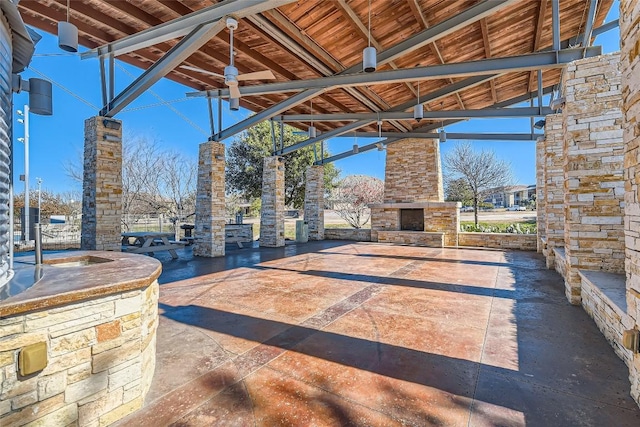 view of patio / terrace featuring an outdoor stone fireplace