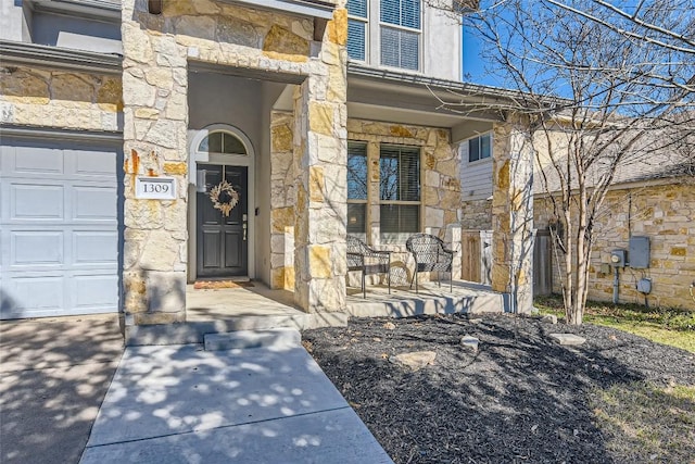 entrance to property with a garage and covered porch