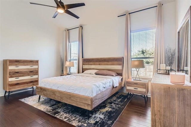 bedroom with dark wood-type flooring and multiple windows