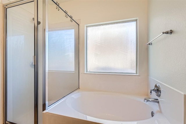 bathroom featuring plus walk in shower