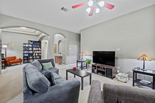 carpeted living room with ceiling fan