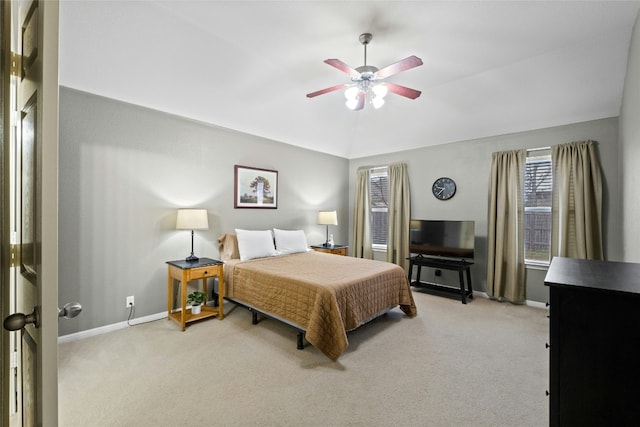 bedroom featuring light carpet, vaulted ceiling, and ceiling fan