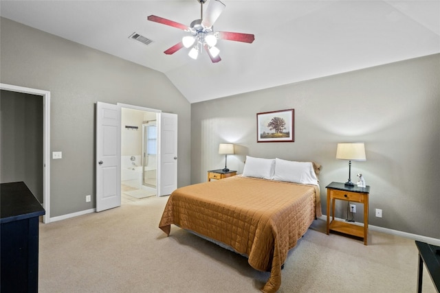 bedroom featuring vaulted ceiling, connected bathroom, light colored carpet, and ceiling fan