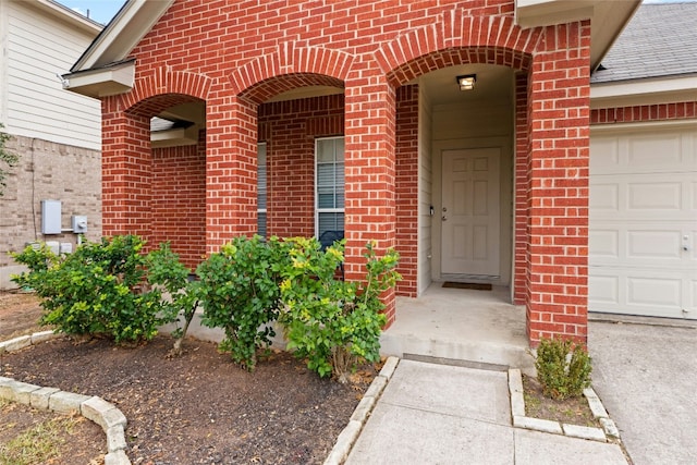 doorway to property with a garage