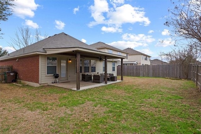 back of house with a yard, an outdoor hangout area, and a patio area