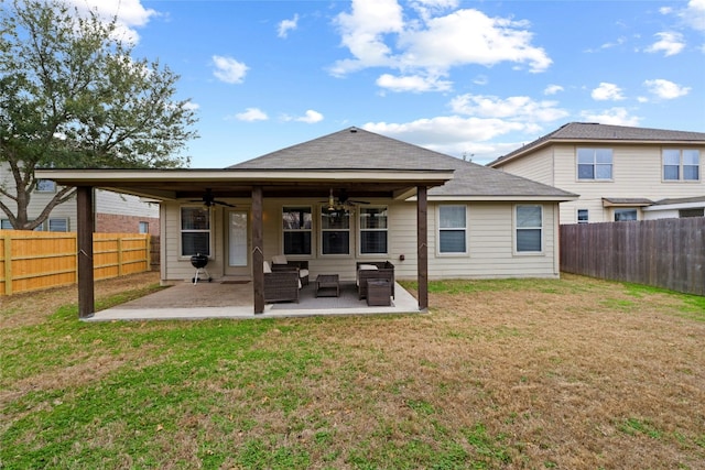 rear view of house with ceiling fan, a yard, and a patio area