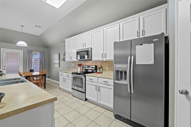 kitchen with sink, light tile patterned floors, white cabinets, and appliances with stainless steel finishes