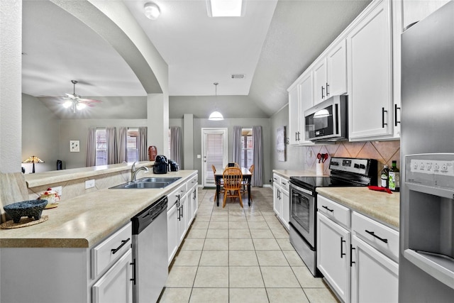 kitchen featuring white cabinetry, hanging light fixtures, light tile patterned floors, and appliances with stainless steel finishes