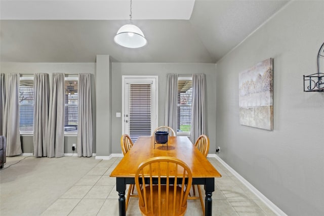 dining room featuring lofted ceiling and light tile patterned flooring