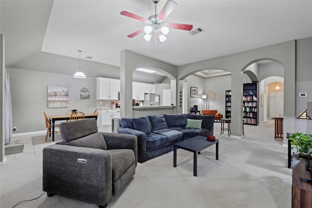 living room with ceiling fan and light colored carpet