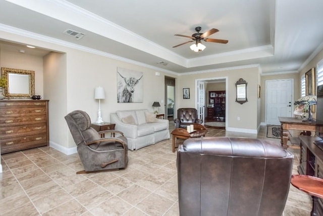 living room with crown molding, ceiling fan, a raised ceiling, and light tile patterned floors