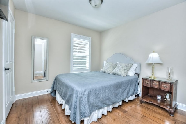 bedroom with hardwood / wood-style floors