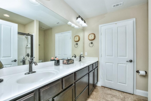 bathroom with vanity, an enclosed shower, and tile patterned floors