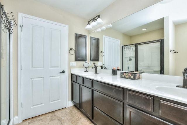 bathroom featuring vanity, a shower with shower door, and tile patterned floors