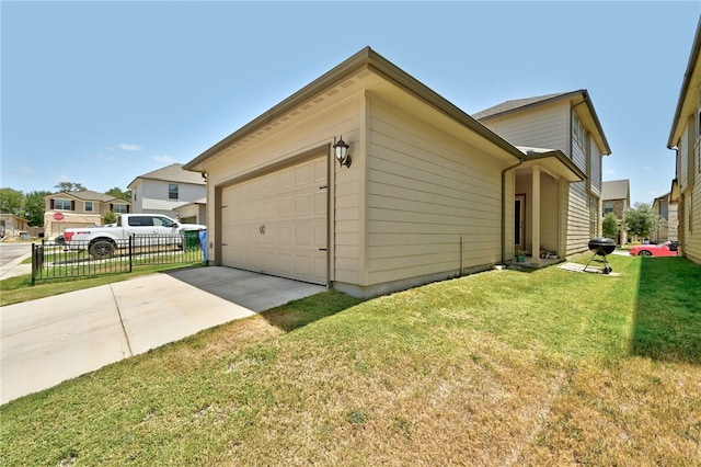 view of side of home featuring a garage and a lawn