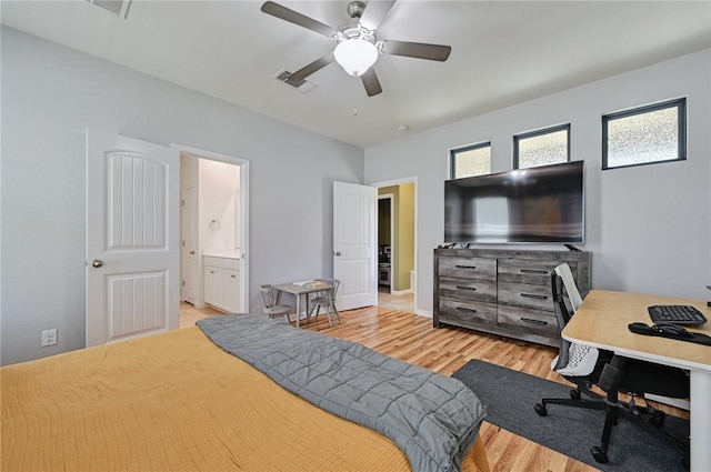 bedroom with ensuite bathroom, ceiling fan, and light wood-type flooring