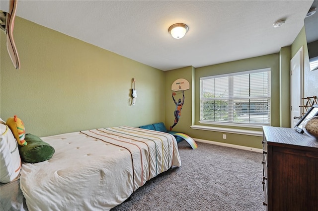 bedroom with a textured ceiling and carpet flooring