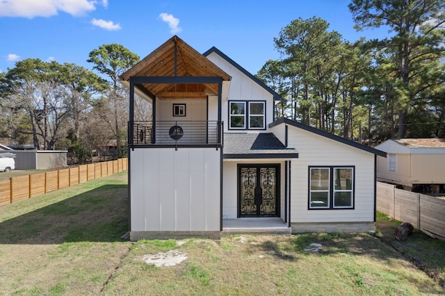 view of front facade featuring french doors and a front lawn