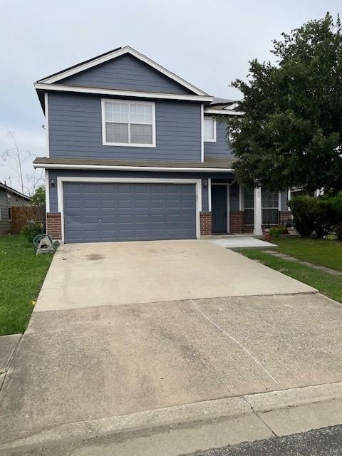 view of front of house with a garage and a front lawn