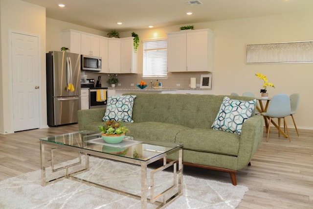 living room with light hardwood / wood-style flooring