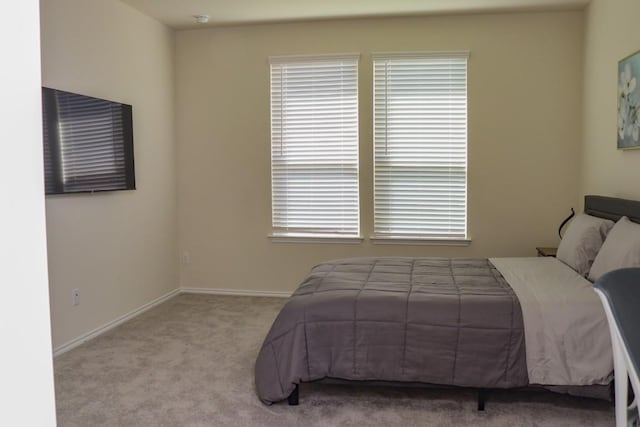 bedroom featuring light colored carpet