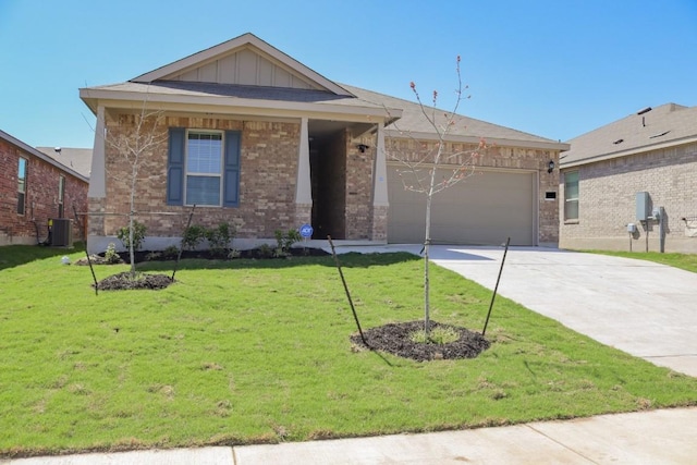 single story home featuring cooling unit, a garage, and a front yard