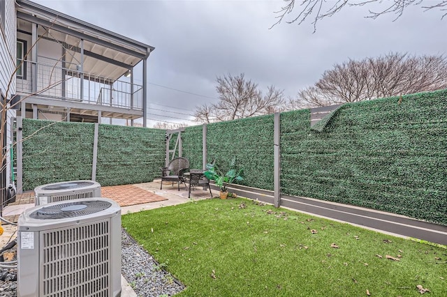 view of yard featuring a patio and central AC