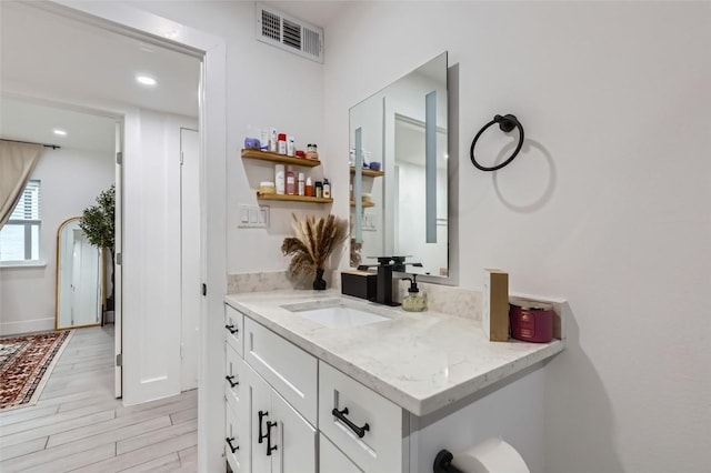 bathroom with vanity and hardwood / wood-style floors