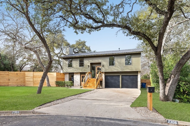 raised ranch with a garage and a front lawn