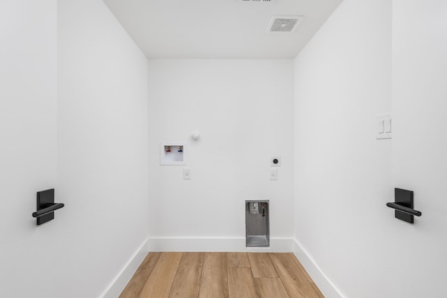 laundry room with hardwood / wood-style flooring, hookup for an electric dryer, hookup for a gas dryer, and hookup for a washing machine