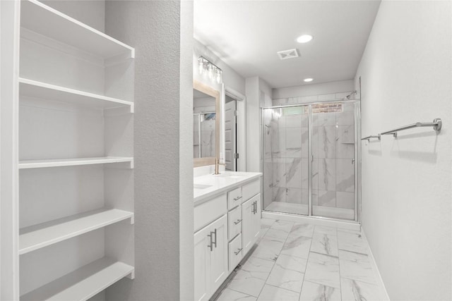 bathroom featuring marble finish floor, visible vents, vanity, and a marble finish shower