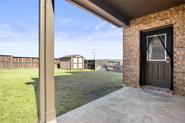 view of yard with a patio, a storage unit, an outdoor structure, and a fenced backyard