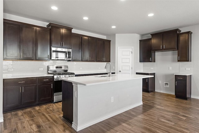 798 Eves Necklace Dr, Buda, TX 78610 - kitchen with stainless steel appliances, a sink, dark wood-style flooring, backsplash, and recessed lighting