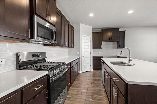 798 Eves Necklace Dr, Buda, TX 78610 - kitchen featuring stainless steel appliances, a sink, tasteful backsplash, light countertops, and recessed lighting