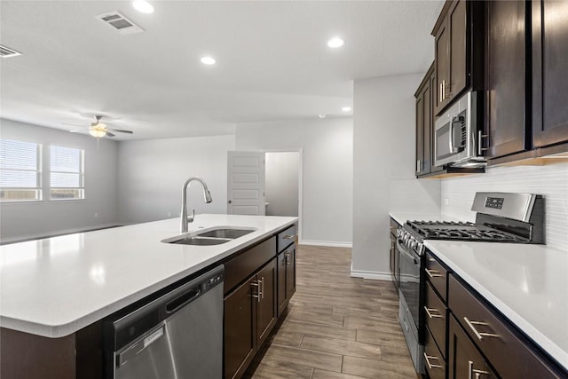 798 Eves Necklace Dr, Buda, TX 78610 - kitchen with stainless steel appliances, a sink, ceiling fan, light countertops, and a kitchen island with sink
