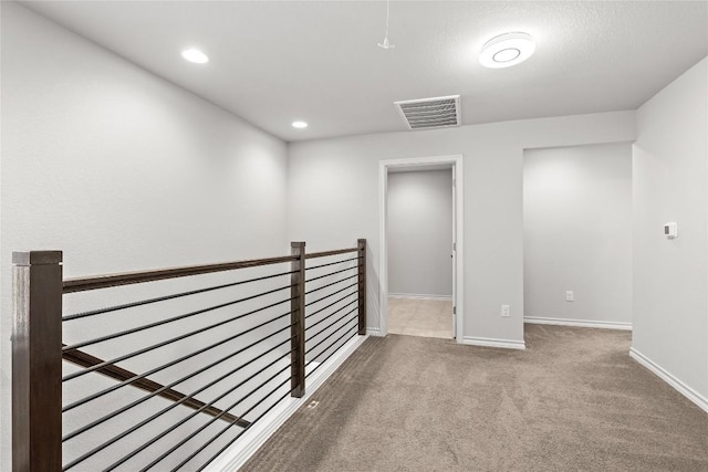 spare room with carpet, visible vents, baseboards, and recessed lighting