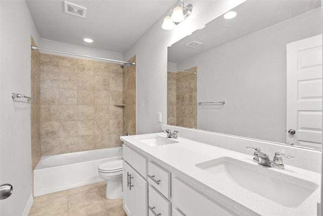 full bath featuring toilet, tile patterned flooring, visible vents, and a sink