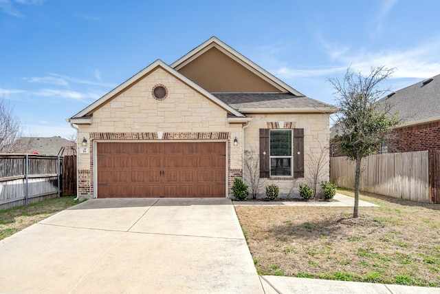 view of front of house featuring driveway, stone siding, fence, roof with shingles, and a garage