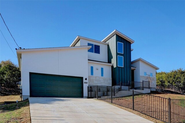 4067 Outpost Trce, Lago Vista, TX 78645 - contemporary home with stone siding, driveway, stucco siding, and board and batten siding