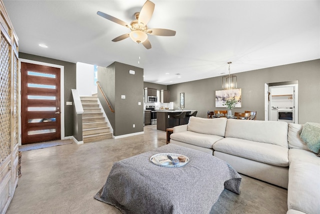 4067 Outpost Trce, Lago Vista, TX 78645 - living area featuring ceiling fan, finished concrete flooring, stairway, a chandelier, and recessed lighting