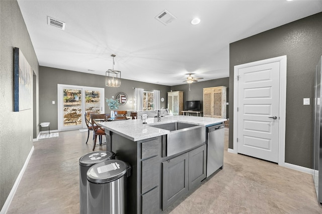 kitchen with ceiling fan with notable chandelier, dishwasher, sink, hanging light fixtures, and a kitchen island with sink