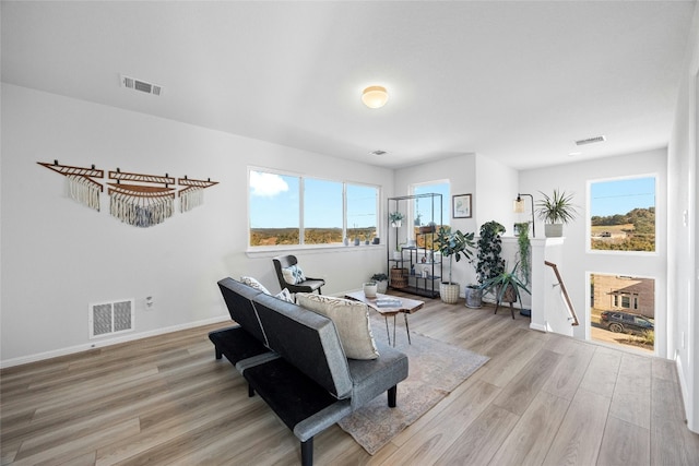 living room with a wealth of natural light and light wood-type flooring