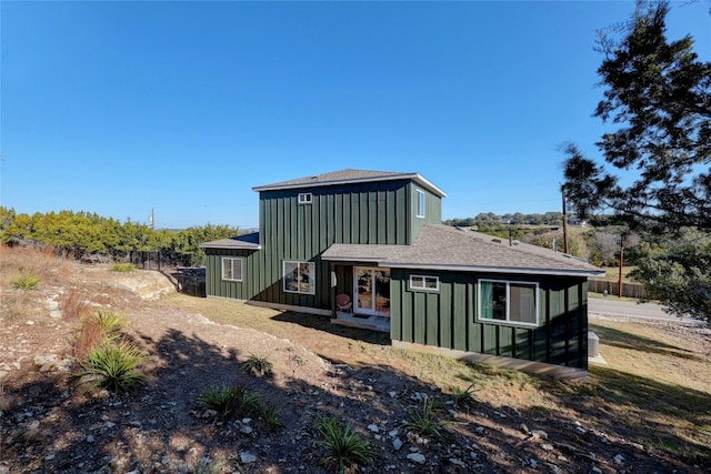 4067 Outpost Trce, Lago Vista, TX 78645 - back of house featuring board and batten siding and roof with shingles