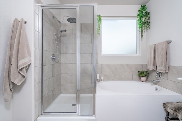 bathroom featuring independent shower and bath