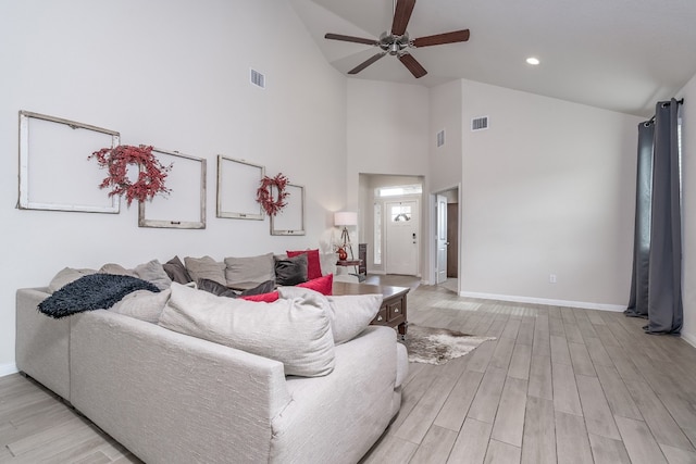 living room featuring vaulted ceiling, ceiling fan, and light wood-type flooring