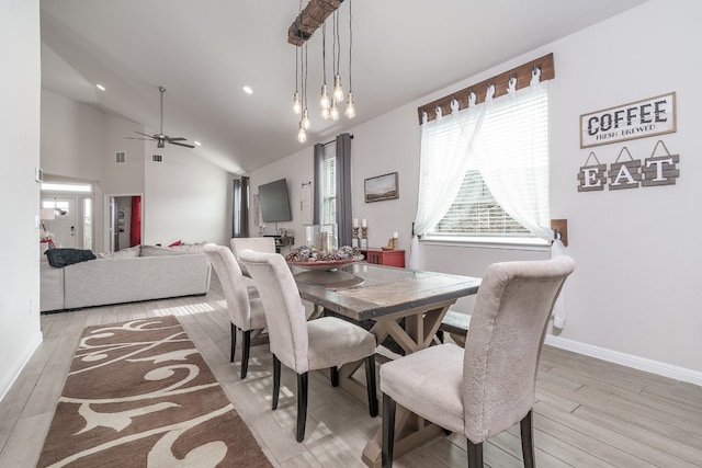 dining room featuring ceiling fan, high vaulted ceiling, and light hardwood / wood-style floors