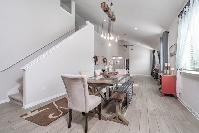 dining space featuring ceiling fan, lofted ceiling, and light hardwood / wood-style floors