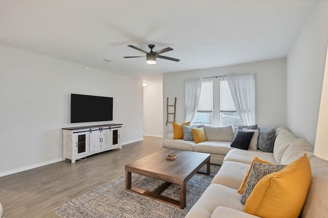 living room with hardwood / wood-style floors and ceiling fan