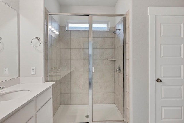 bathroom with vanity and a shower with shower door