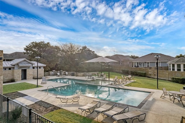 view of swimming pool with a yard and a patio area